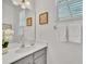 Bathroom featuring a vanity with white quartz countertop, a large mirror, and modern lighting at 2536 Shanti Dr, Kissimmee, FL 34746