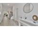 Bright hallway with gray tile flooring, white walls, and modern decor that leads to stairs and the living area at 2536 Shanti Dr, Kissimmee, FL 34746