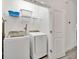 Well-equipped laundry room including modern washer, dryer, shelving, and bright lighting at 2536 Shanti Dr, Kissimmee, FL 34746