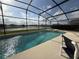 Inviting screened-in pool with lake view at 2577 Aster Cove Ln, Kissimmee, FL 34758