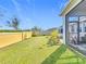 Expansive backyard showcasing a screened lanai with a partial view of outdoor furnishings at 281 Piave St, Haines City, FL 33844