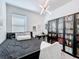 This bedroom features a black bed frame and bookshelf with elegant décor and a modern light fixture at 281 Piave St, Haines City, FL 33844