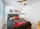 Bright bedroom with a ceiling fan, black padded headboard, grey carpet, and white trim at 281 Piave St, Haines City, FL 33844