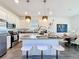 Bright and airy kitchen featuring a large island, pendant lighting, and stainless steel appliances at 281 Piave St, Haines City, FL 33844