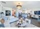 Stylish open-concept living room with modern chandelier, white sofa, and seamless flow to kitchen at 281 Piave St, Haines City, FL 33844