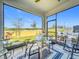 Screened-in patio featuring a glass table, ceiling fan, and seating area with natural light at 281 Piave St, Haines City, FL 33844