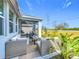 Screened-in patio area with outdoor furniture surrounded by tropical plants at 281 Piave St, Haines City, FL 33844