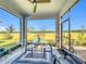 Screened-in patio featuring a glass table, ceiling fan, and seating area with a view at 281 Piave St, Haines City, FL 33844