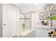 Elegant bathroom showcasing dual vanities, geometric tile floor and a glass enclosed shower at 31792 Broadwater Ave, Leesburg, FL 34748