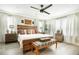 Comfortable bedroom boasting a ceiling fan, wooden bedframe, and natural light at 31792 Broadwater Ave, Leesburg, FL 34748