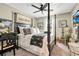 Chic bedroom with four-poster bed, Paris-themed decor, and ample natural light at 31792 Broadwater Ave, Leesburg, FL 34748