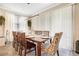 Bright dining area featuring a table for eight with modern light fixture and blinds at 31792 Broadwater Ave, Leesburg, FL 34748