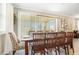 Elegant dining room boasts a table for eight with modern light fixture and lots of natural light at 31792 Broadwater Ave, Leesburg, FL 34748