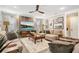 Comfortable living room featuring modern decor, a ceiling fan, and tile floors at 31792 Broadwater Ave, Leesburg, FL 34748