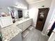 Bright bathroom featuring a double vanity with granite countertops and a decorative cabinet at 3285 Majestic Oak Dr, St Cloud, FL 34771