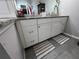 This bathroom vanity features granite countertops and gray tile flooring at 3285 Majestic Oak Dr, St Cloud, FL 34771