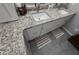 This bathroom features granite countertops and gray tile flooring at 3285 Majestic Oak Dr, St Cloud, FL 34771