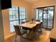 Dining room featuring a modern table with seating for six, and a large window overlooking the pool at 3285 Majestic Oak Dr, St Cloud, FL 34771