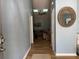 Inviting entryway with wood floors leads to a bright living room featuring a ceiling fan and neutral decor at 3285 Majestic Oak Dr, St Cloud, FL 34771