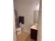 Bright bathroom features a toilet, vanity, and neutral tile flooring at 3470 Goldeneye Ln, St Cloud, FL 34772