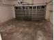 Empty garage space with a functional roll-up door and concrete floor at 3470 Goldeneye Ln, St Cloud, FL 34772