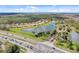 Expansive aerial view showcasing a well-planned community with a scenic lake and surrounding greenery at 3723 Isles Arbor Ln, Kissimmee, FL 34746