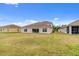 Expansive backyard with lawn, tile roof, and views of the neighboring houses at 3723 Isles Arbor Ln, Kissimmee, FL 34746