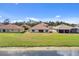 Water view of the home's rear exterior, surrounded by well-maintained grass, from the lake at 3723 Isles Arbor Ln, Kissimmee, FL 34746