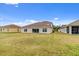 Expansive backyard with lawn, tile roof, and views of the neighboring houses at 3723 Isles Arbor Ln, Kissimmee, FL 34746