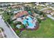 The community pool and playground are surrounded by palm trees and lush landscaping at 3723 Isles Arbor Ln, Kissimmee, FL 34746