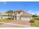 Two-story home boasting a tile roof, two-car garage, and well-maintained landscaping with lovely curb appeal at 3723 Isles Arbor Ln, Kissimmee, FL 34746