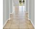 Hallway featuring neutral tile flooring and access to view with abundant natural light at 3723 Isles Arbor Ln, Kissimmee, FL 34746