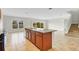 Well-lit kitchen with granite countertop island, tile floors, and backyard view at 3723 Isles Arbor Ln, Kissimmee, FL 34746