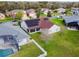 Aerial view of a single story home featuring solar panels and large screened lanai at 4119 Maidu Ct, St Cloud, FL 34772