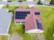 Home with installed solar panels, screened in lanai, and lawn at 4119 Maidu Ct, St Cloud, FL 34772