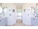 Bright bathroom featuring double sinks, tile floors and an entrance into a bedroom at 4119 Maidu Ct, St Cloud, FL 34772