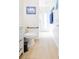 Bright bathroom featuring a modern toilet, long wood-look tile, and a view through the doorway, providing a clean space at 4119 Maidu Ct, St Cloud, FL 34772