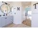 Light-filled bathroom featuring a double vanity and entrance to a bedroom at 4119 Maidu Ct, St Cloud, FL 34772