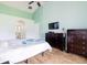 Cozy bedroom with wood floors, ceiling fan and access to ensuite bathroom at 4119 Maidu Ct, St Cloud, FL 34772