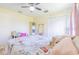 Bright bedroom showcasing light wood floors, a ceiling fan, and a full-length mirror at 4119 Maidu Ct, St Cloud, FL 34772