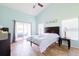 Bright bedroom featuring a sliding glass door, vaulted ceiling, and light wood floors at 4119 Maidu Ct, St Cloud, FL 34772