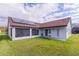 Exterior of a home featuring a screened lanai, solar panels, and lush green lawn at 4119 Maidu Ct, St Cloud, FL 34772