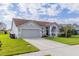 Charming single-story home with a well-manicured lawn, two-car garage, and inviting front entrance at 4119 Maidu Ct, St Cloud, FL 34772