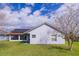 Exterior of a home featuring a screened lanai, solar panels, and lush green lawn at 4119 Maidu Ct, St Cloud, FL 34772