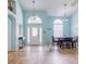 Inviting living area with wood-look floors and natural light from front door at 4119 Maidu Ct, St Cloud, FL 34772