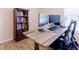 Well-lit office space with a wood desk, modern chair, and a built-in bookcase at 4119 Maidu Ct, St Cloud, FL 34772