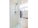 Bright bathroom featuring a glass-enclosed shower with modern fixtures and a window, offering a clean and stylish space at 4119 Maidu Ct, St Cloud, FL 34772