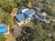 Aerial view of the property with pool and verdant surroundings, providing a private oasis at 4318 Oak Ct, St Cloud, FL 34769