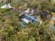 Aerial view of home with pool and deck, surrounded by trees, offering privacy and tranquility at 4318 Oak Ct, St Cloud, FL 34769