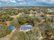 Neighborhood aerial view of home surrounded by lush greenery, near shopping and dining at 4318 Oak Ct, St Cloud, FL 34769